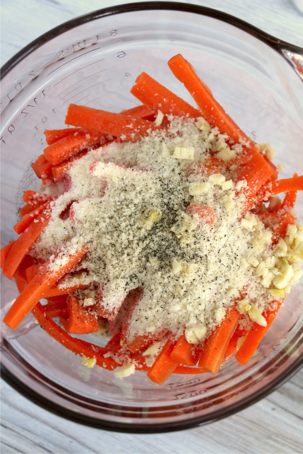 glass bowl filled with carrots and seasonings
