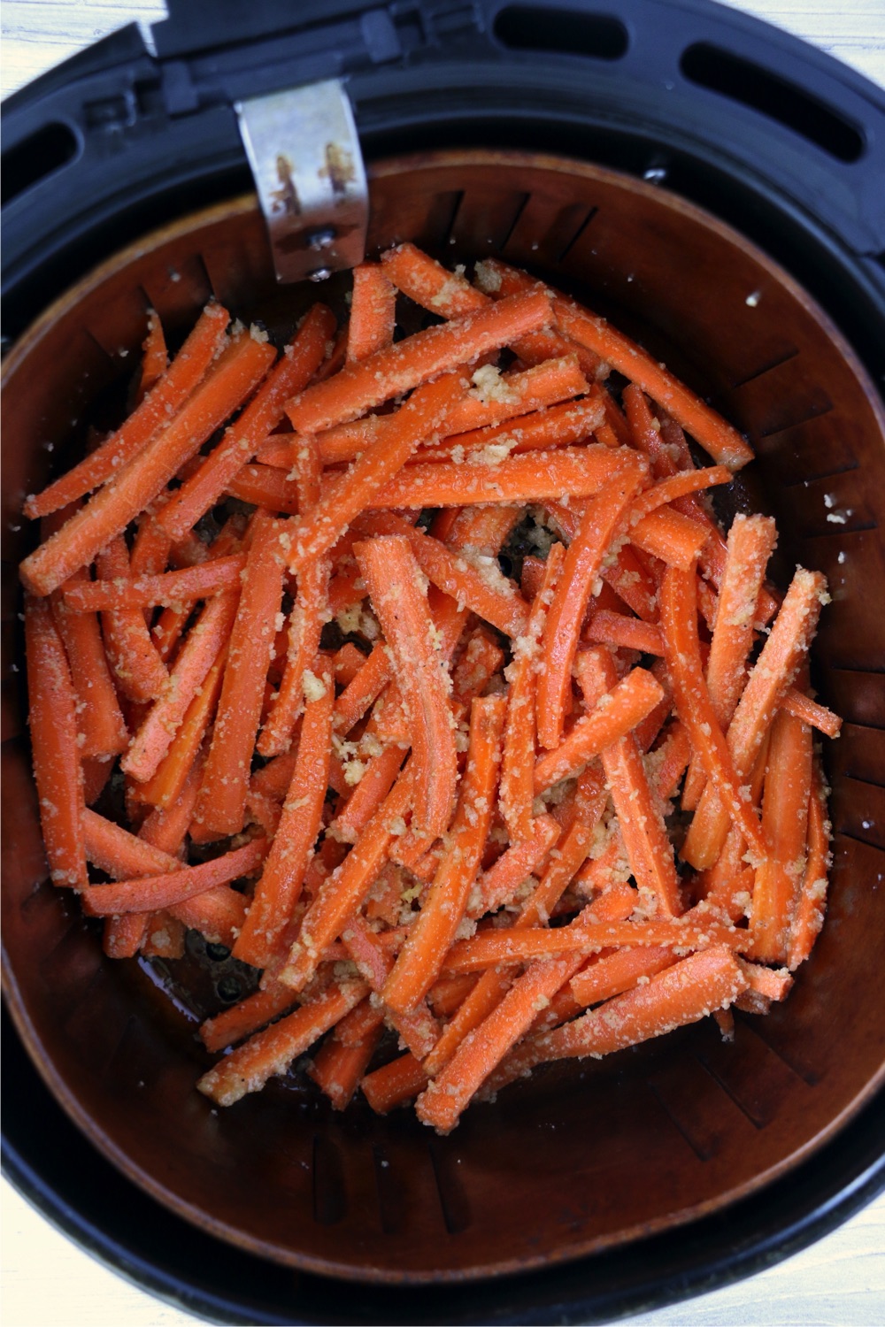 raw carrots in air fryer basket
