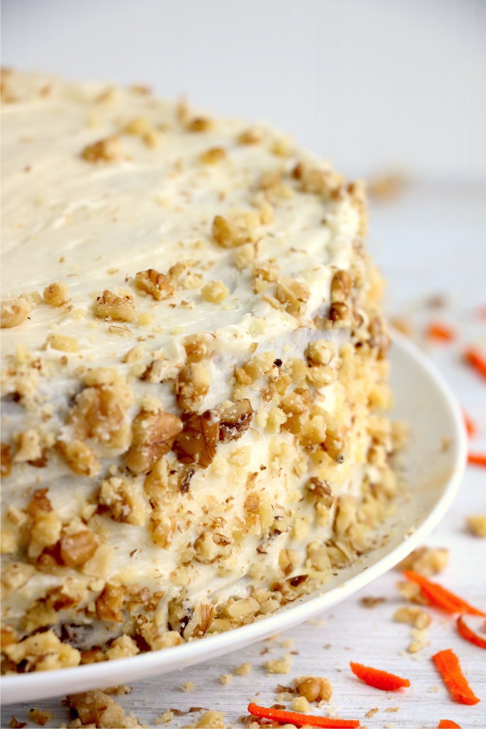 Carrot cake with chopped walnuts on the outside of cake