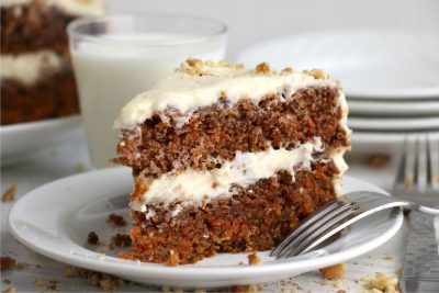 layered carrot cake on a plate with fork