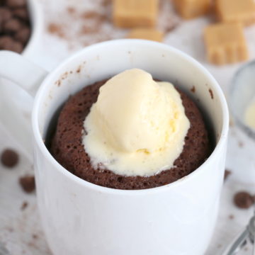 chocolate mug cake with scoop of vanilla ice cream on top