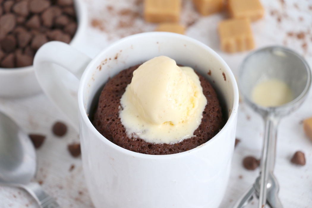 chocolate mug cake with scoop of vanilla ice cream on top
