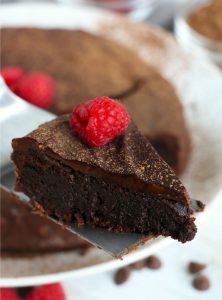 piece of flourless chocolate cake on cake server