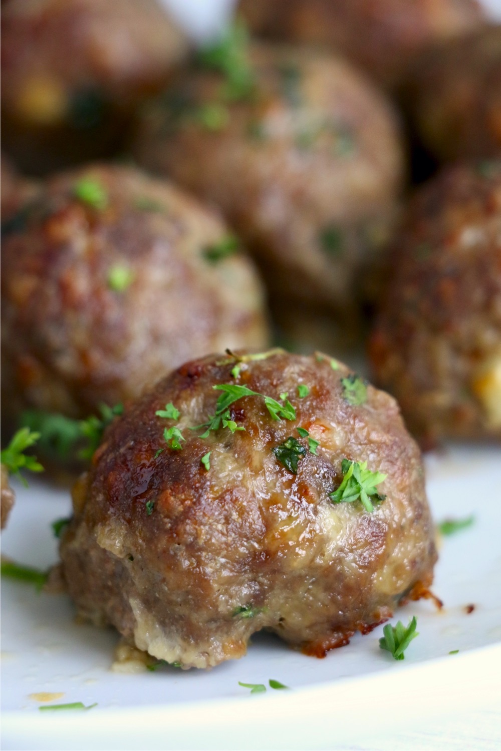 close up of meatball with parsley garnish