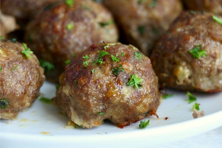 close up of meatball on white plate