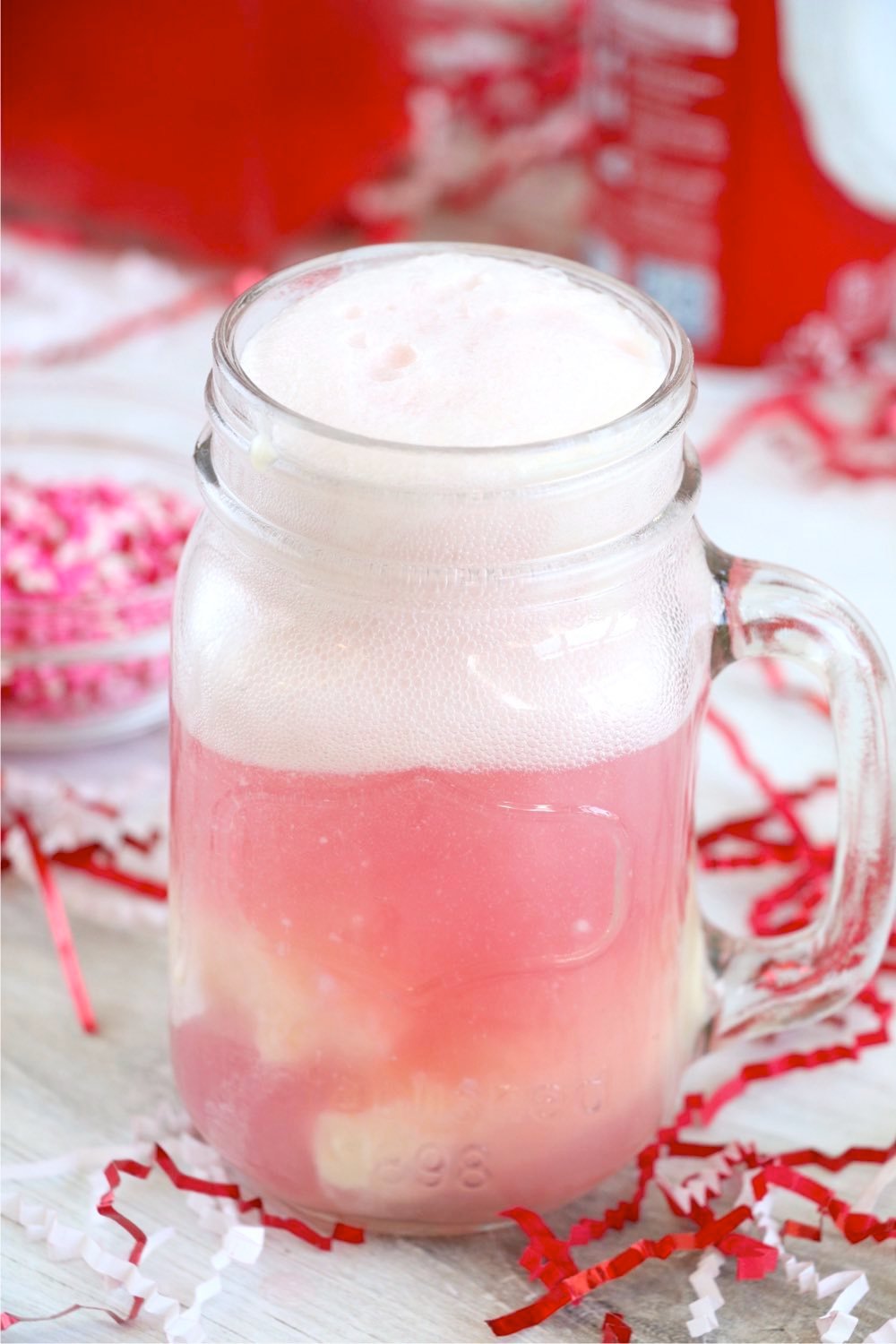 whipped topping in glass with cherry soda and ice cream