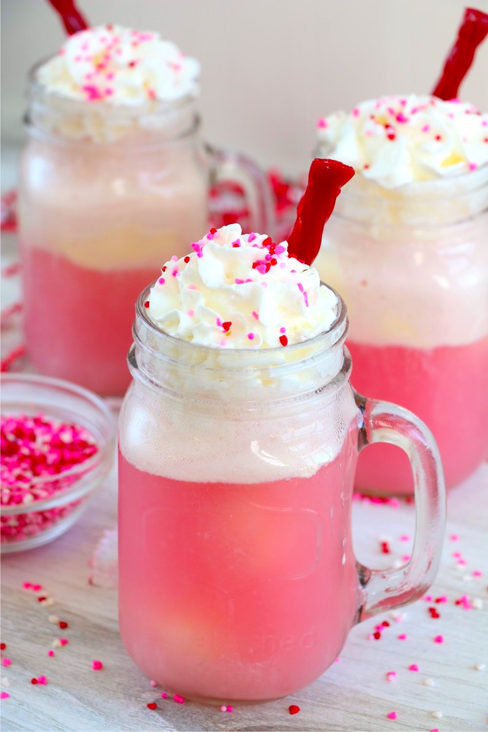 cherry float topped with whipped cream, sprinkles and a licorice straw