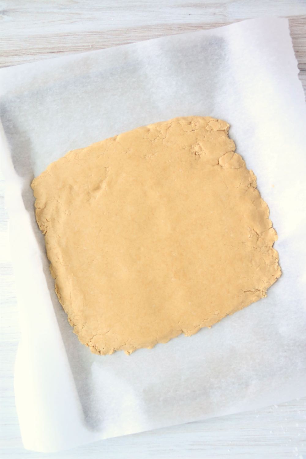 flattened dough on baking sheet