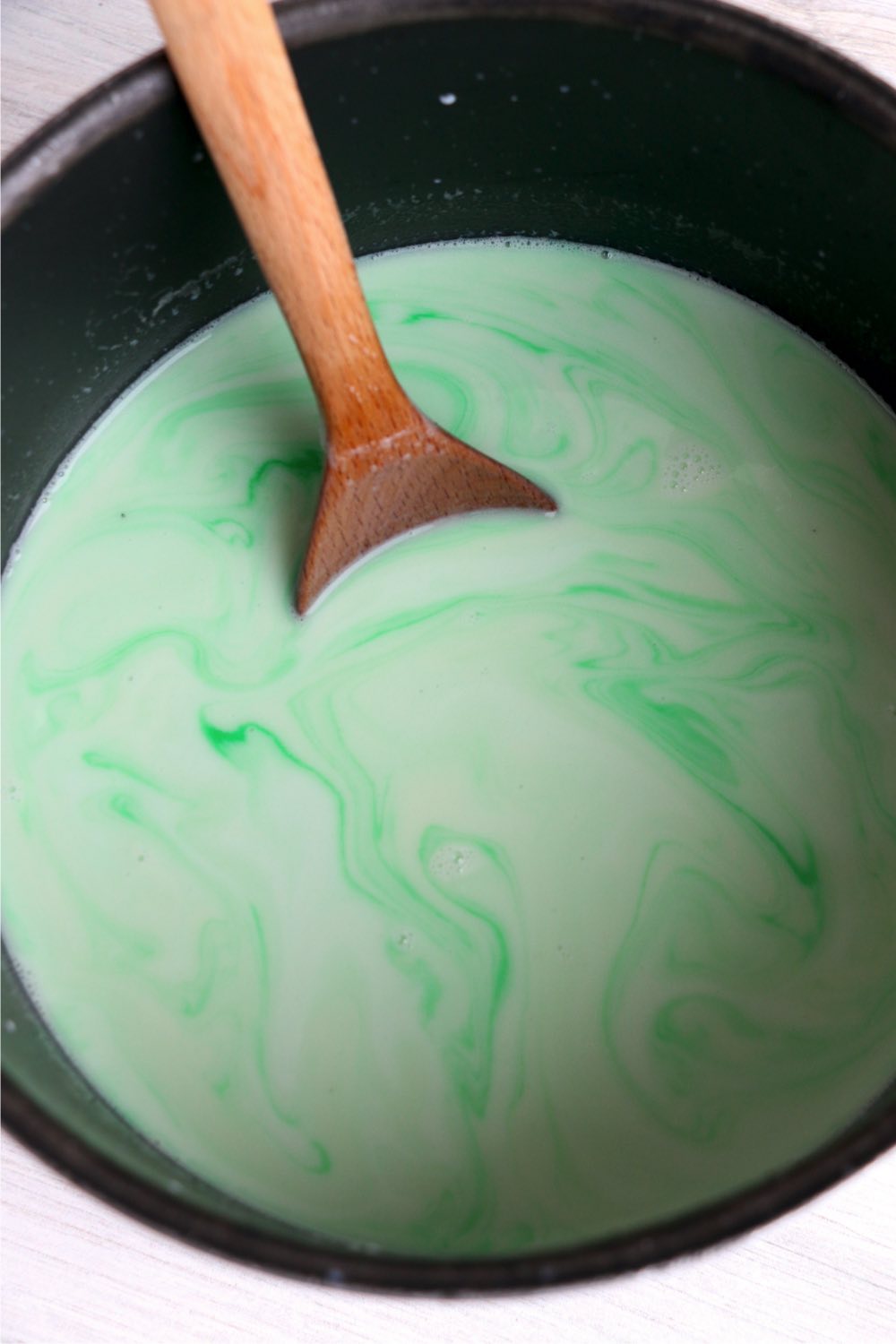 wooden spoon mixing green hot chocolate