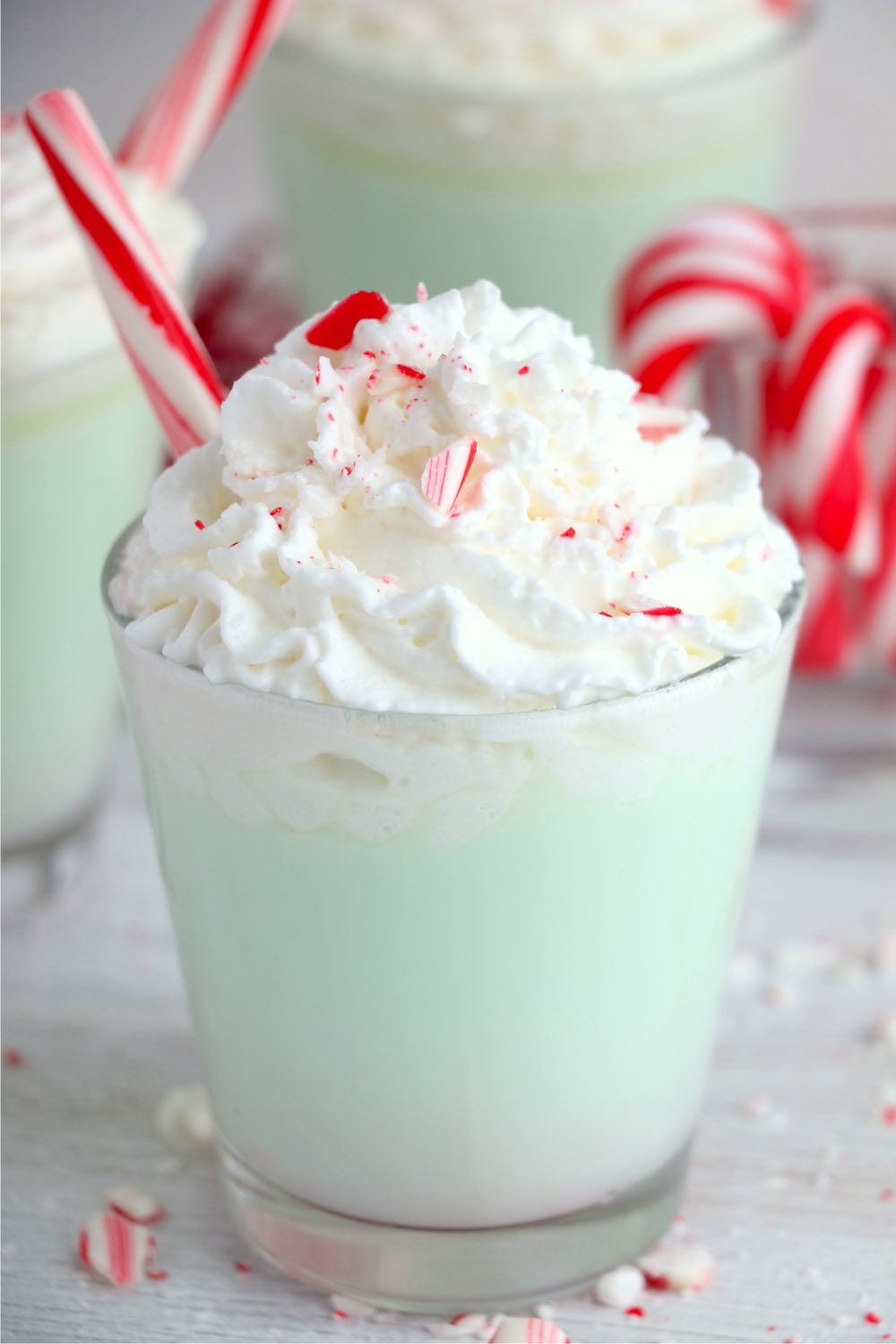 cup of a green drink with whipped topping