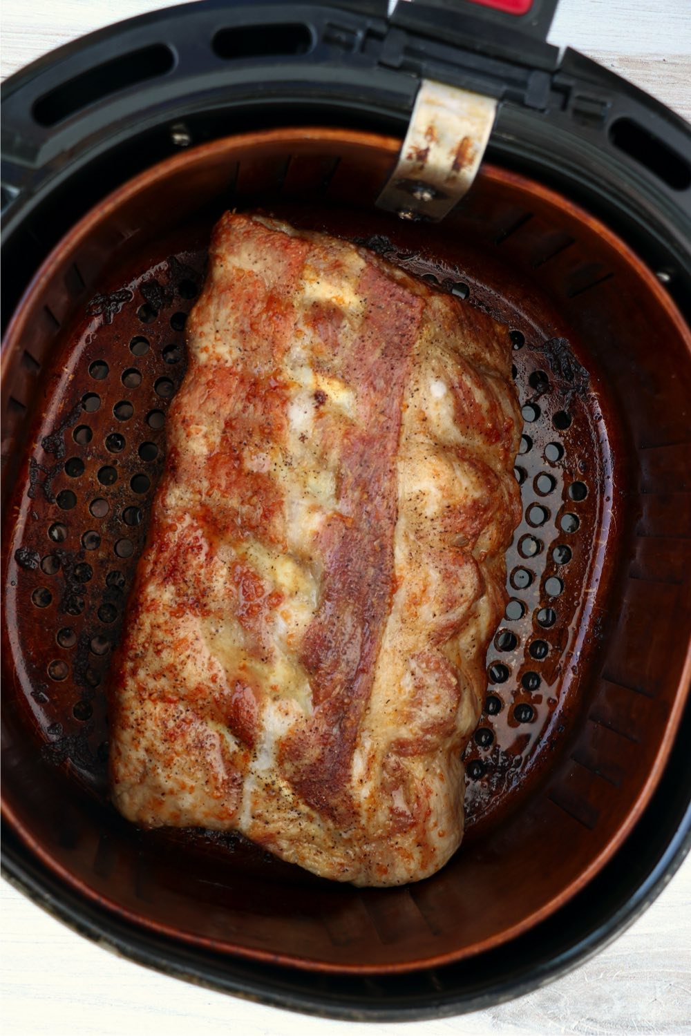 cooked rack of ribs in air fryer basket