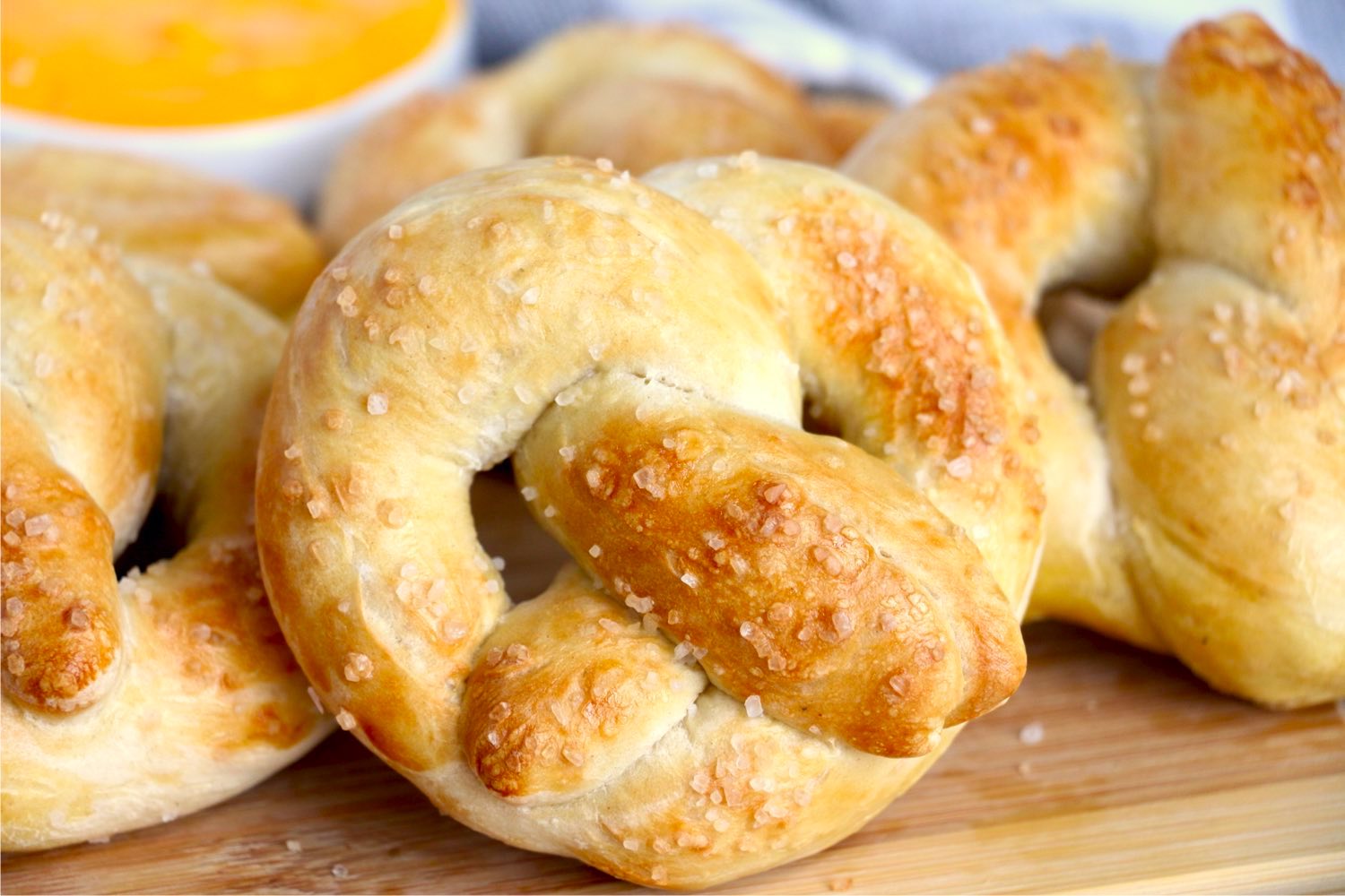 soft pretzels in front of cheese dip