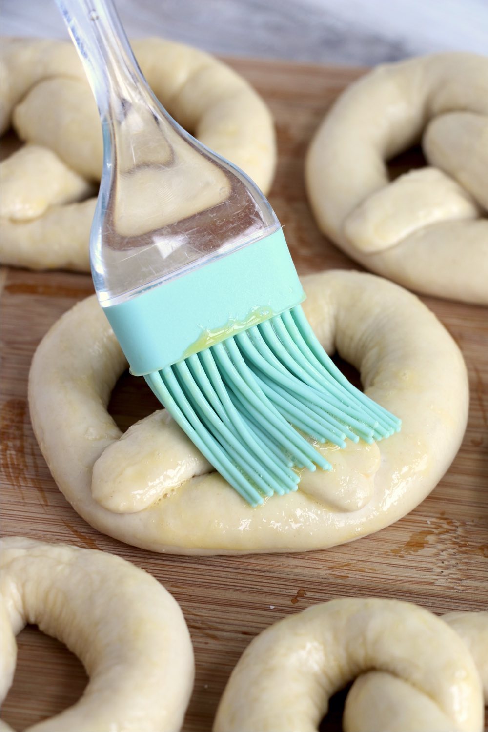 brushing pretzel dough with butter