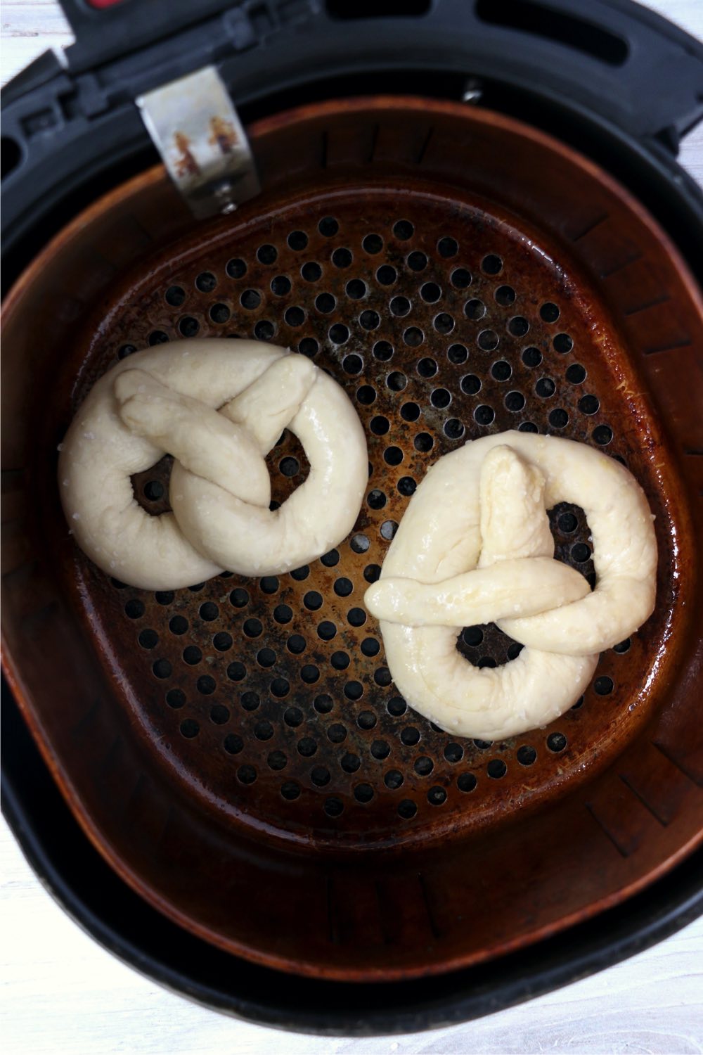 two pretzels in air fryer basket