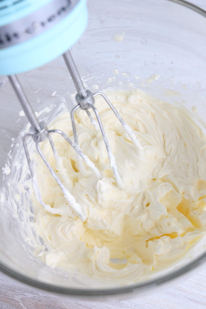 Mixing frosting with hand mixer