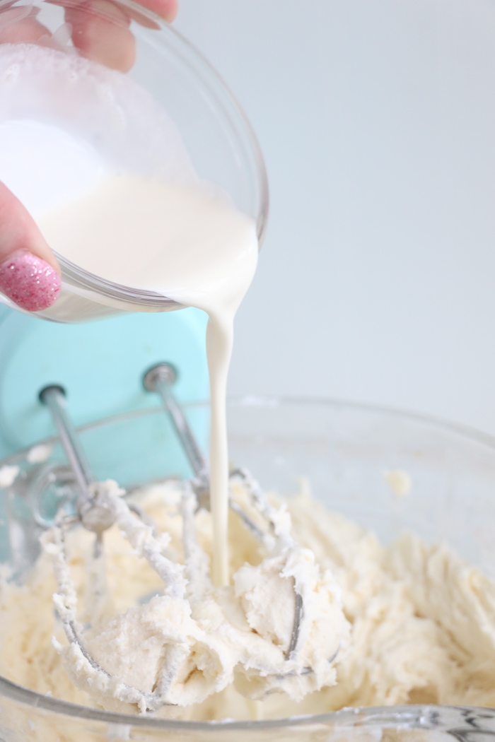 pouring heavy cream into frosting mixture
