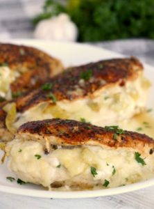 Browned chicken breasts stuffed with artichoke filling