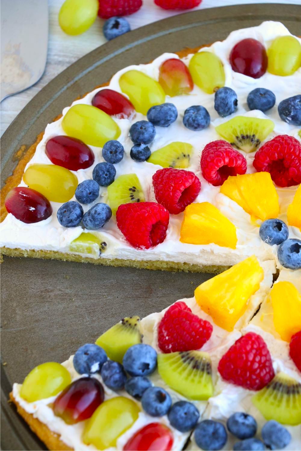 Fruit pizza with piece taken out