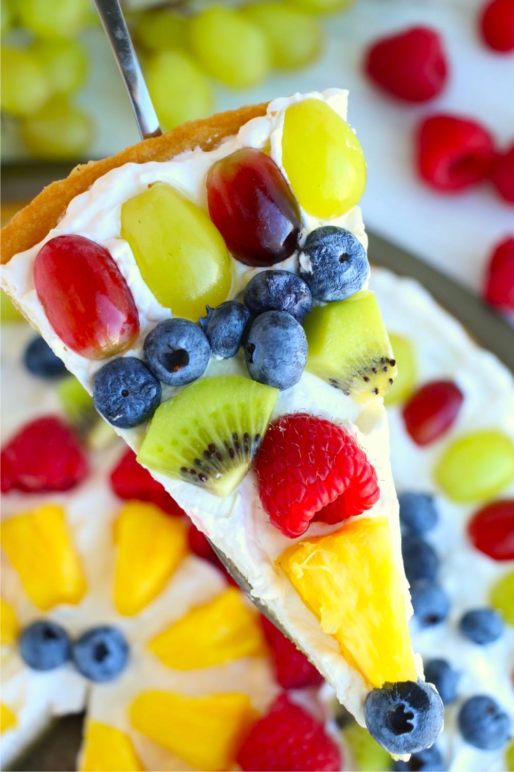 spatula holding a piece of fruit pizza