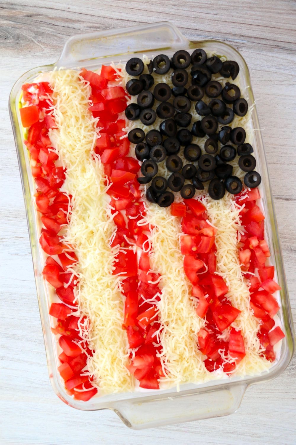 glass pan with taco dip in an American flag design