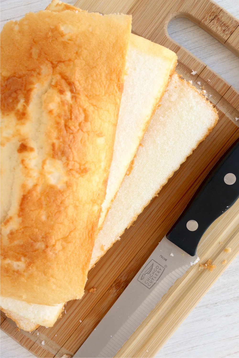 sliced layers of pound cake on cutting board with knife