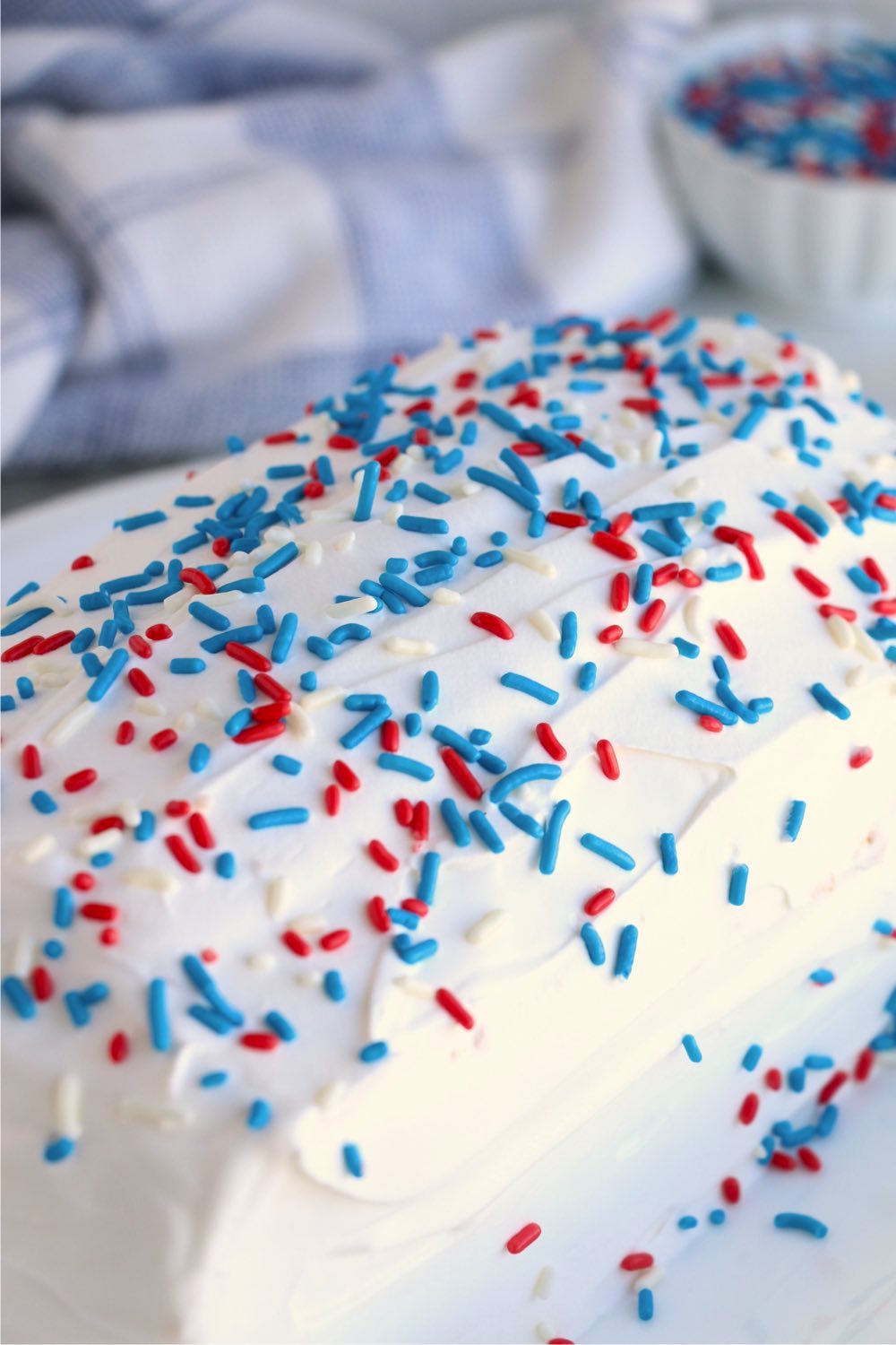Pound cake covered with whipped topping and sprinkles