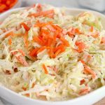 bowl of coleslaw with carrots for garnish