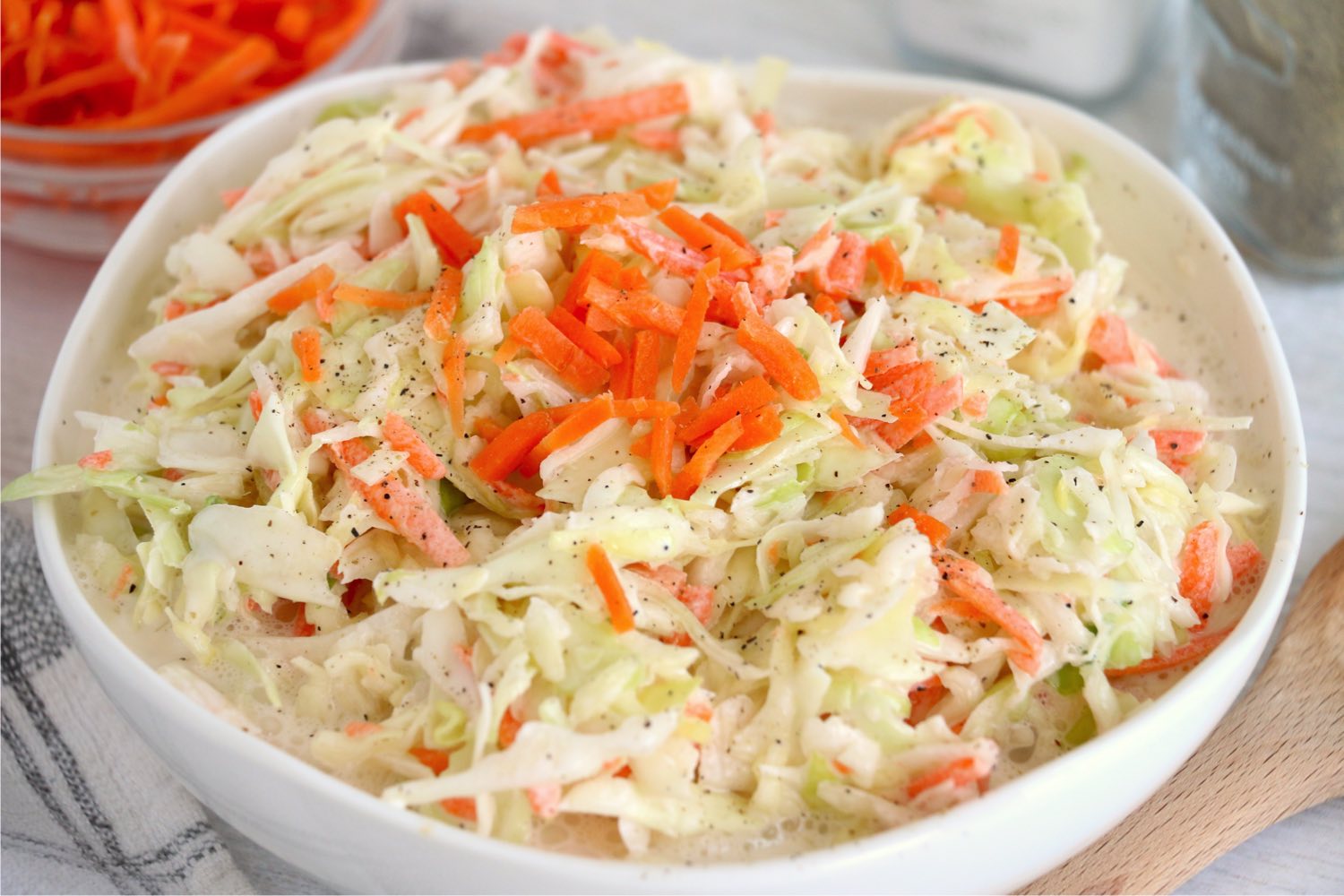 bowl of coleslaw with carrots for garnish