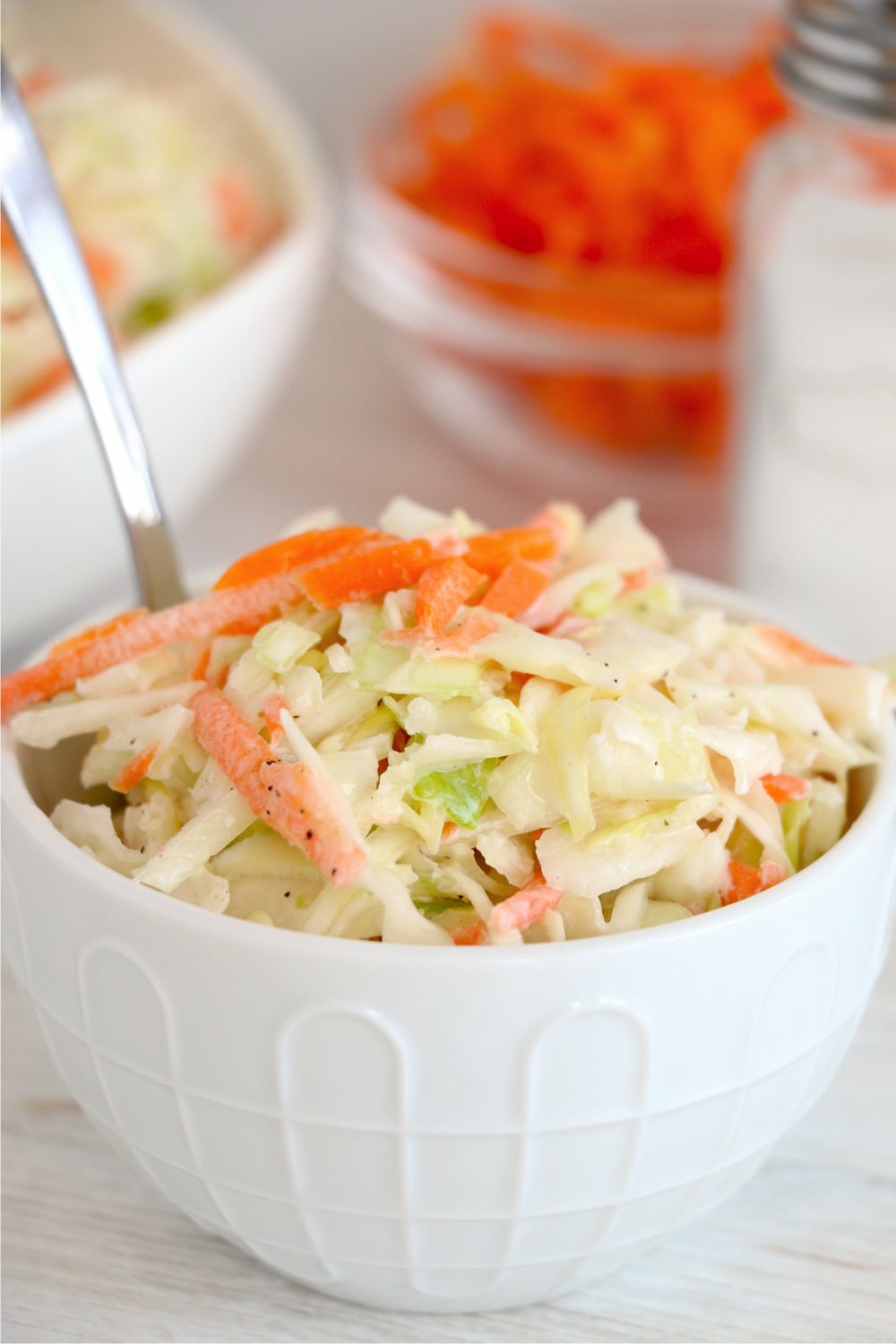 small bowl of coleslaw with spoon