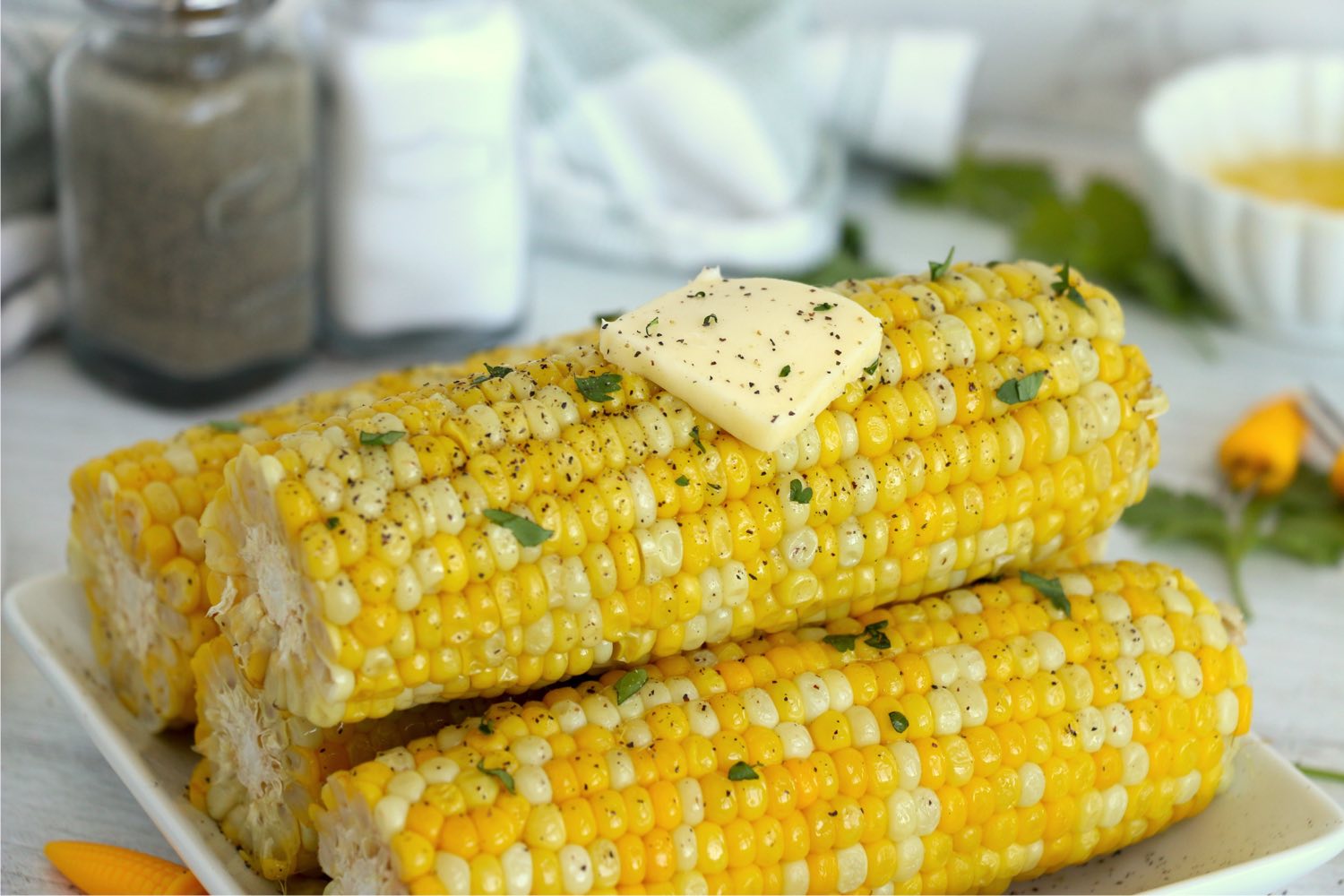 A stack of corn with a pat of butter on top