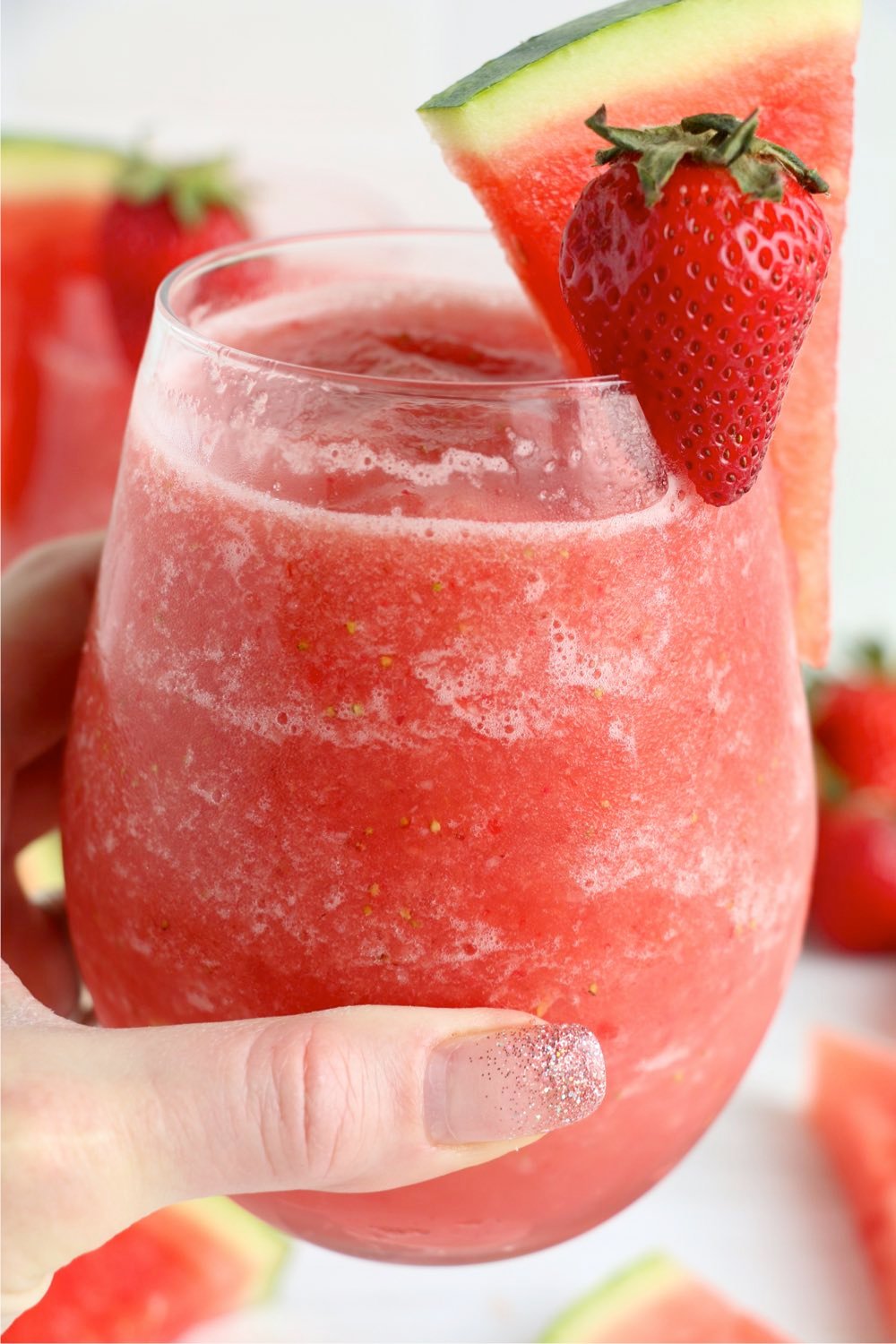 hand holding a frozen strawberry drink