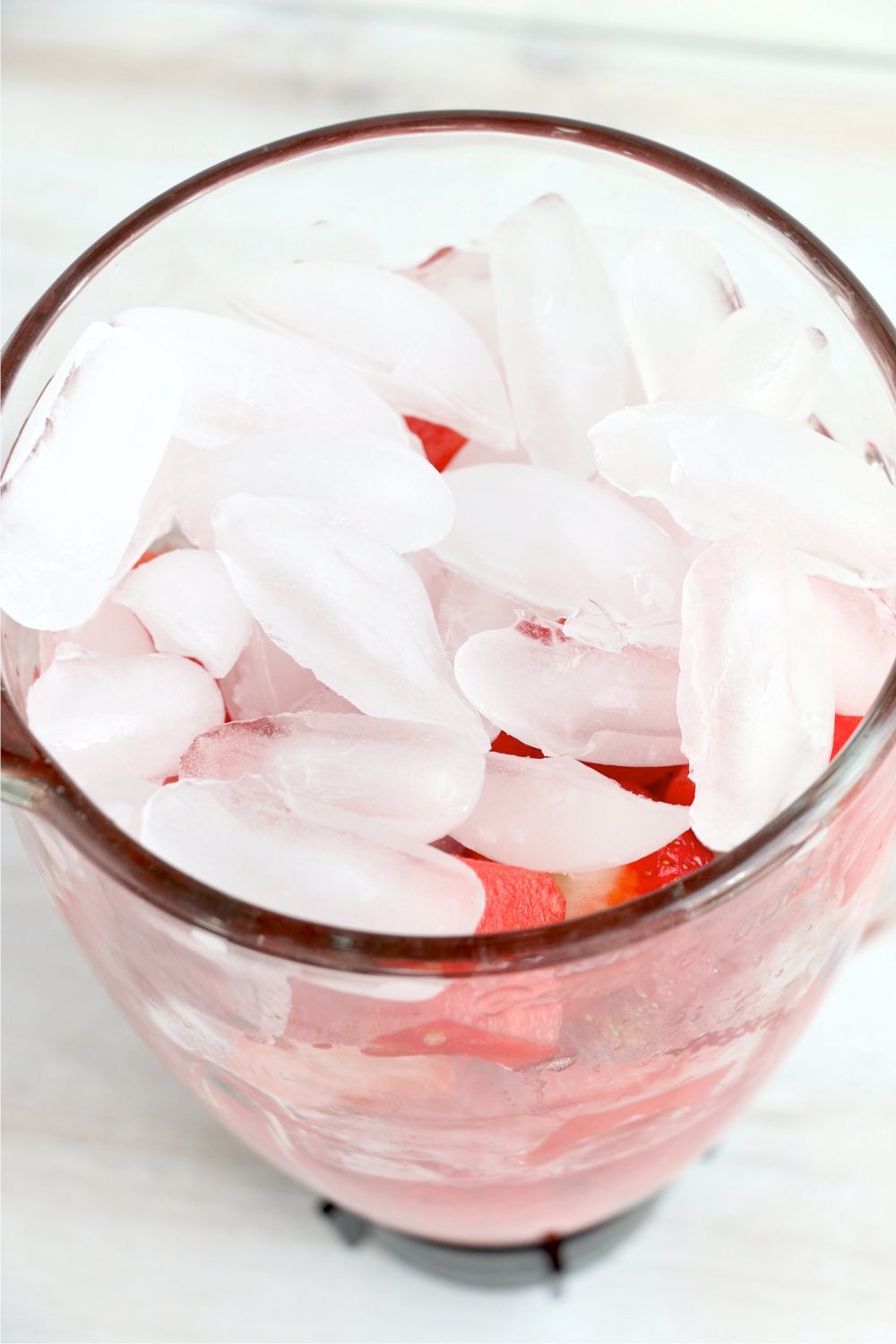 ice cubes on top of strawberries and watermelon