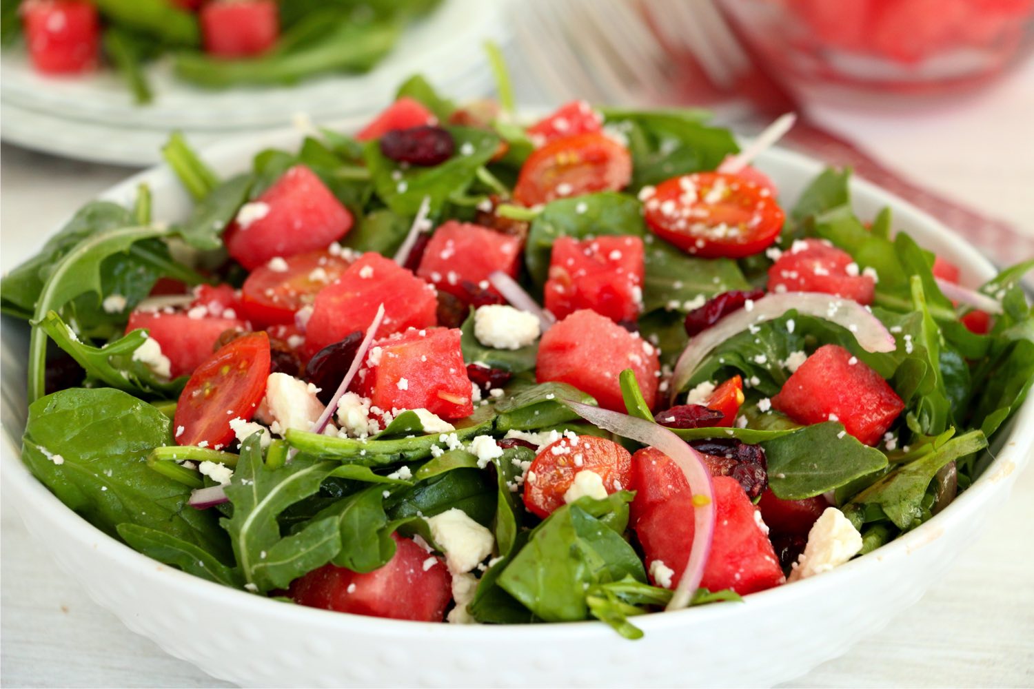bowl of greens, watermelon, onions and feta cheese