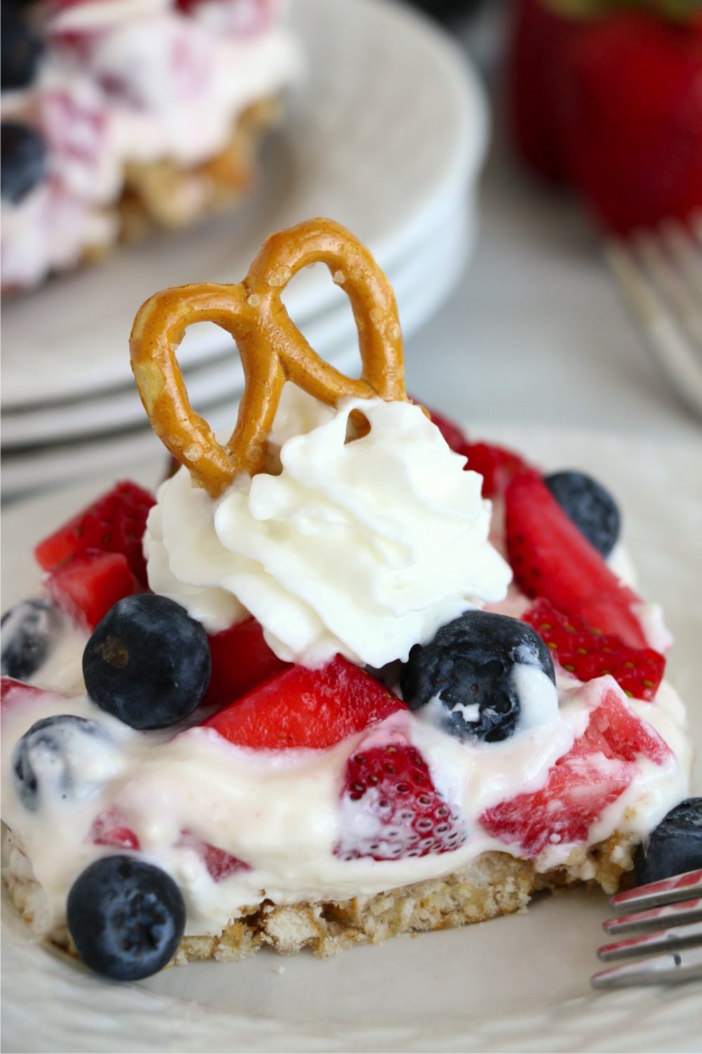 classic pretzel dessert with fresh berries and whipped cream