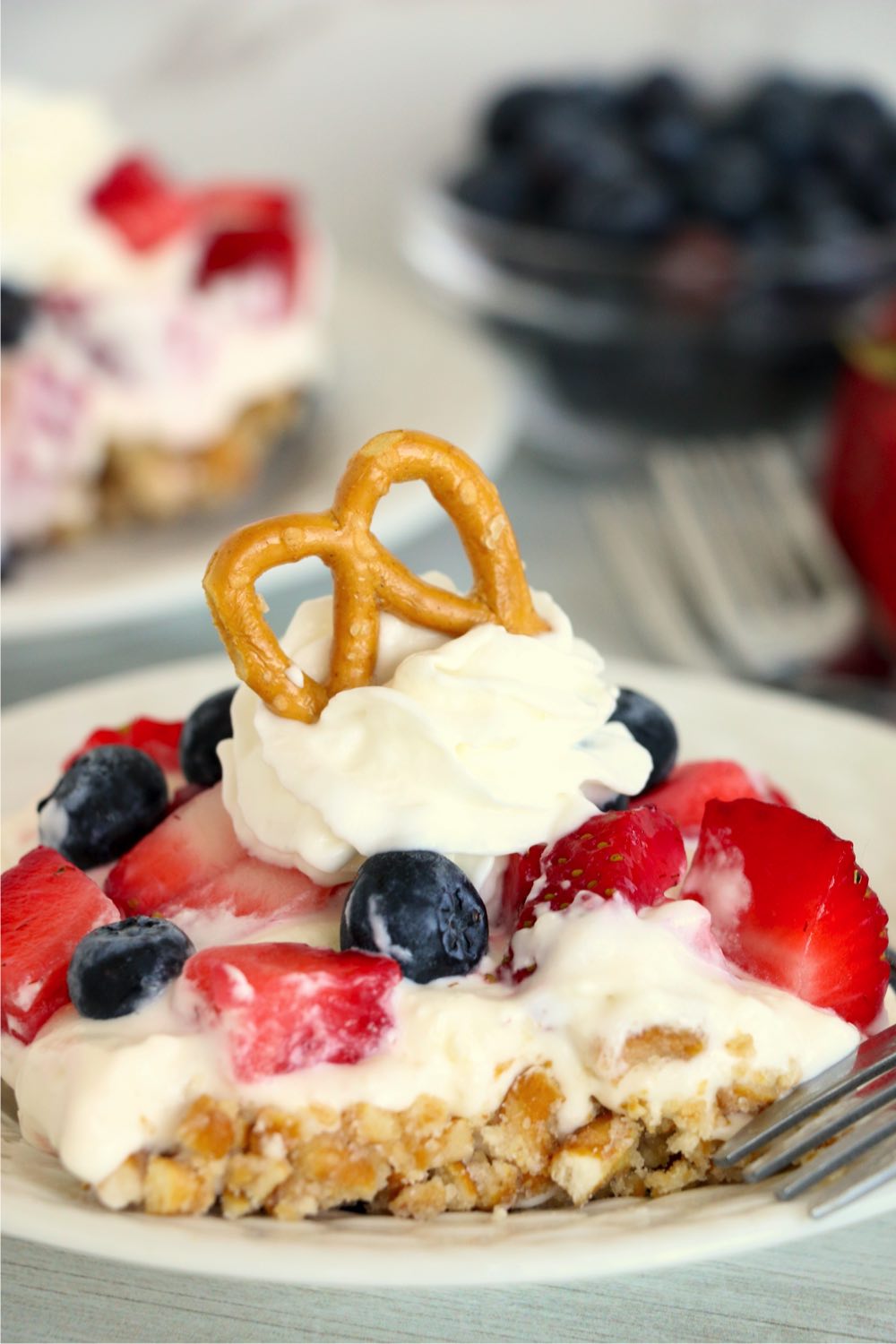 berry pretzel dessert with whipped cream and pretzels