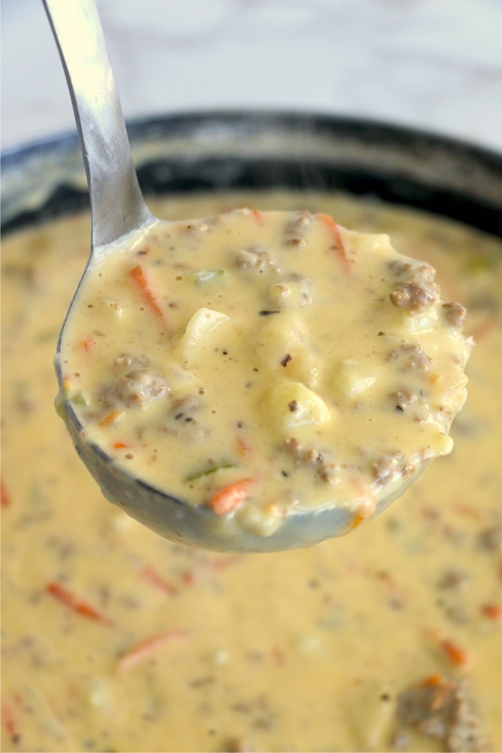 ladle filled with cheeseburger soup