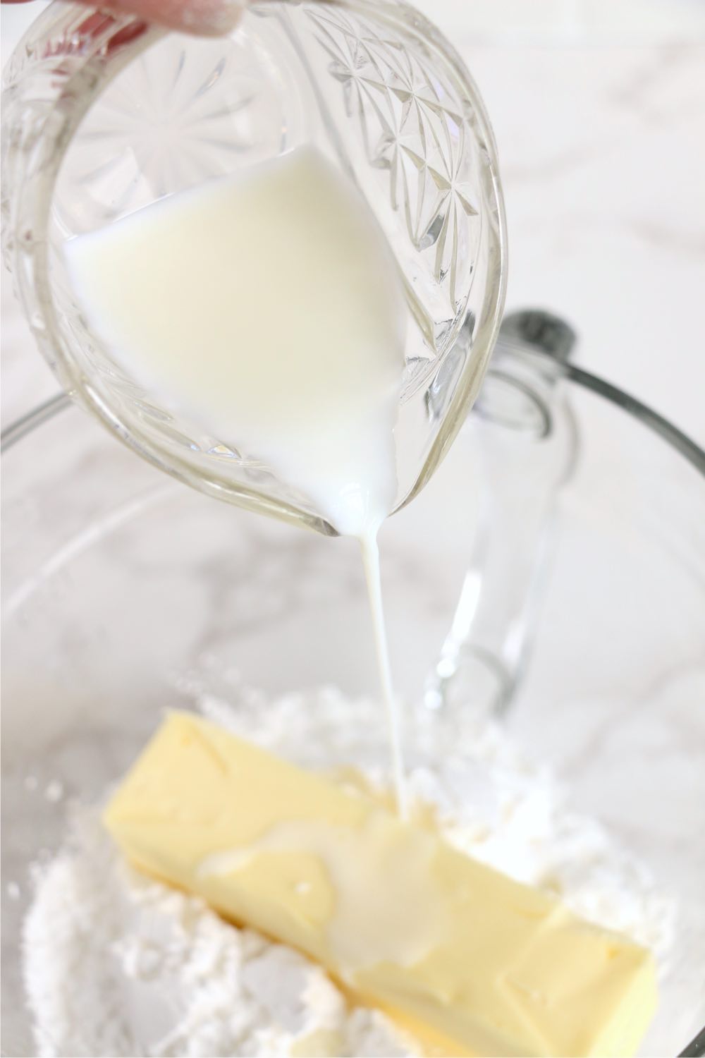 pouring milk into bowl of butter and milk