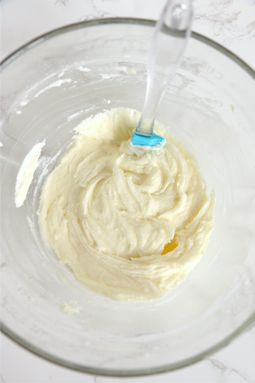 bowl of buttercream frosting in glass bowl