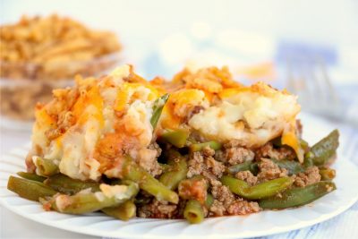 white plate with meat and potato casserole