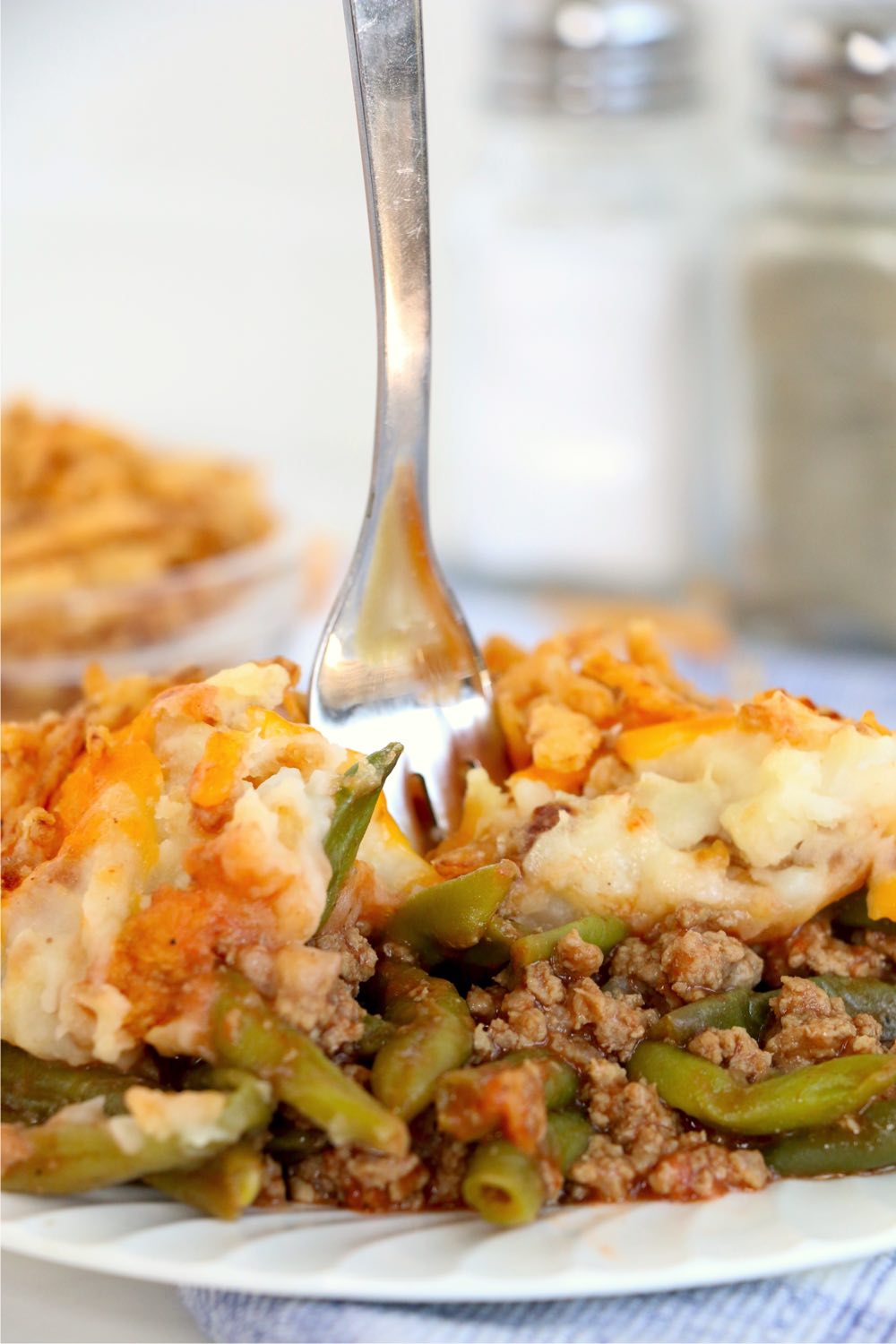 fork digging into potato and ground beef casserole