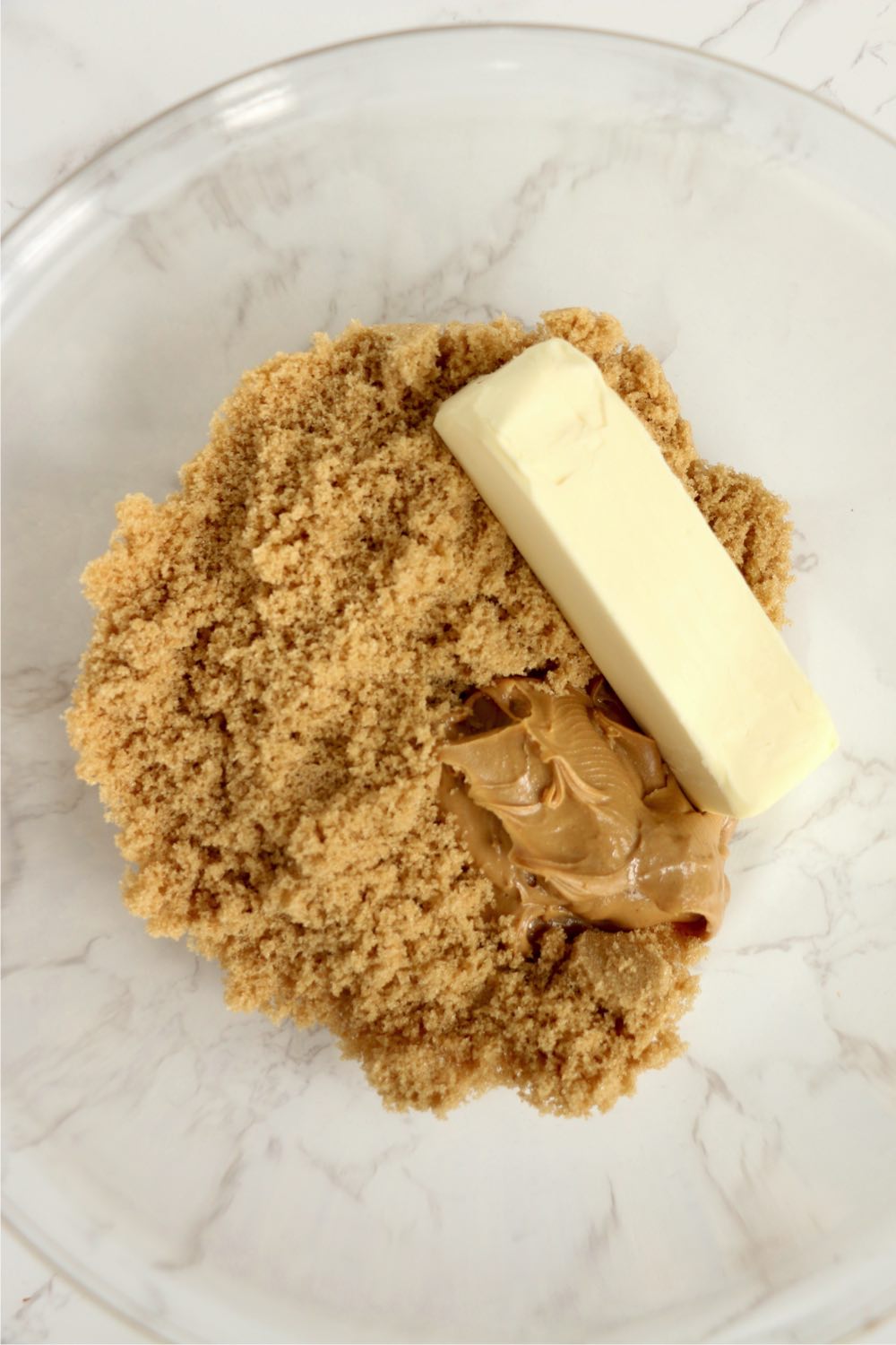 Glass bowl with butter, peanut butter and brown sugar
