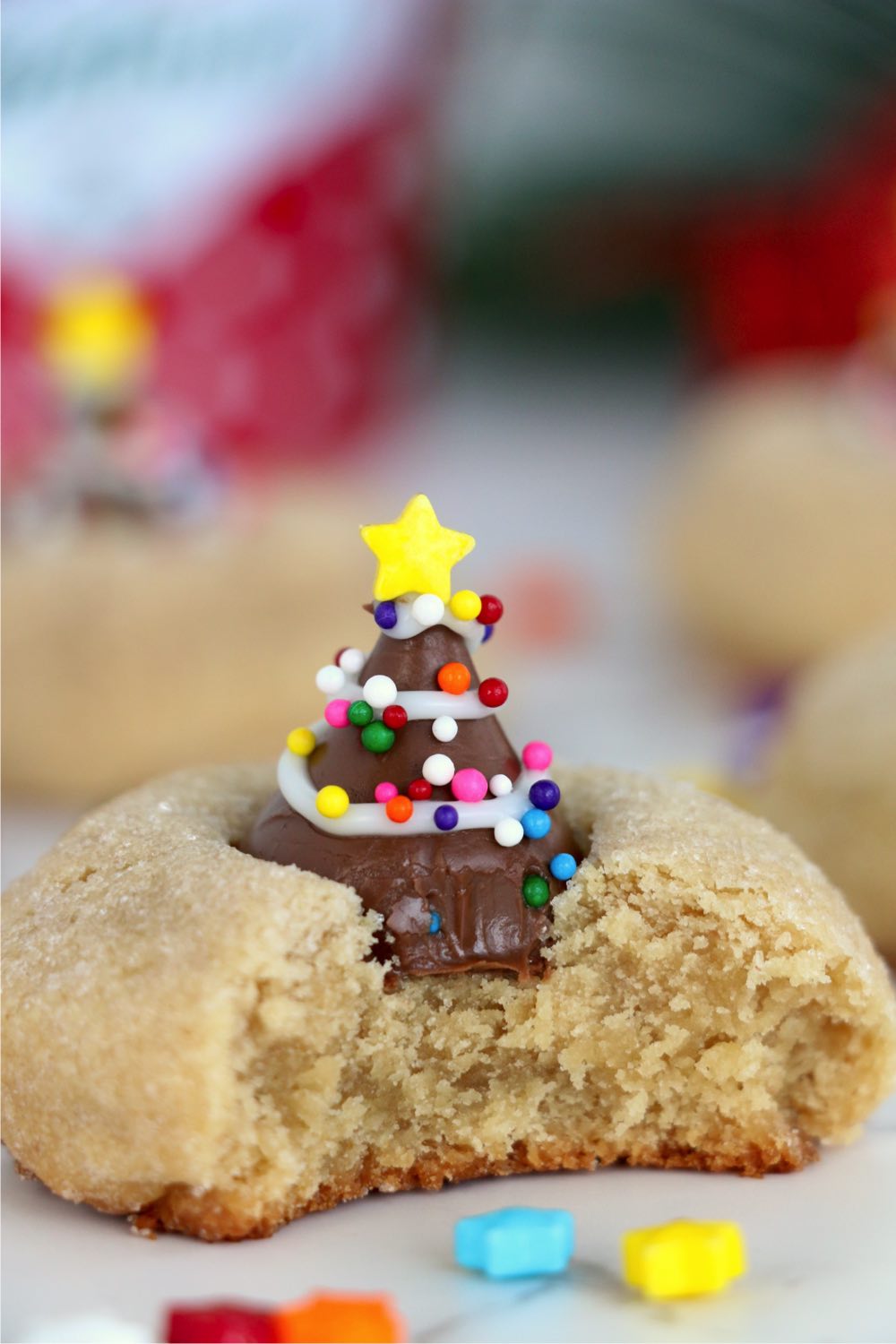 bite out of a Christmas peanut butter blossom