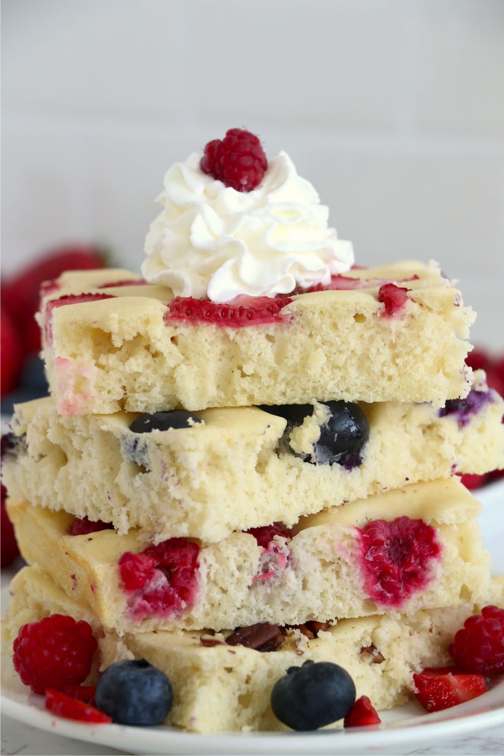 stack of oven pancakes with whipped topping and fruit