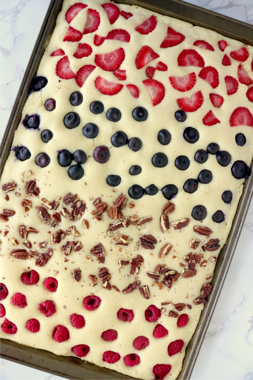 cookie sheet pancake with fresh fruit and nut toppings