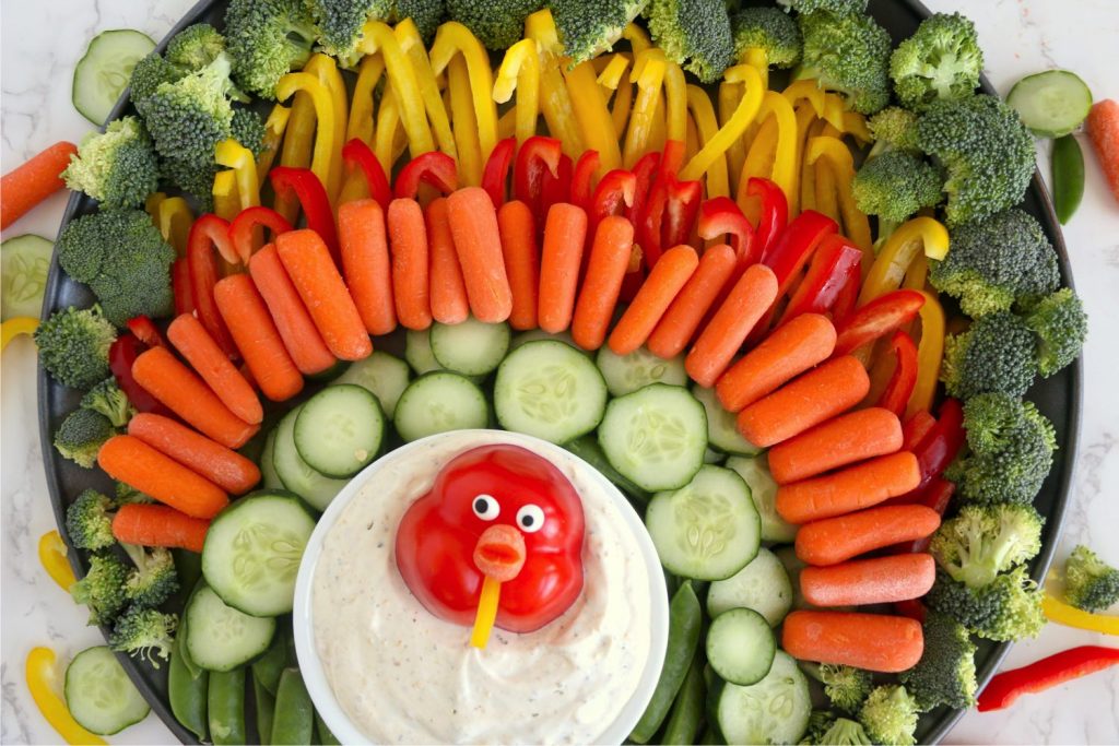 Vegetables arranged in the shape of a turkey.