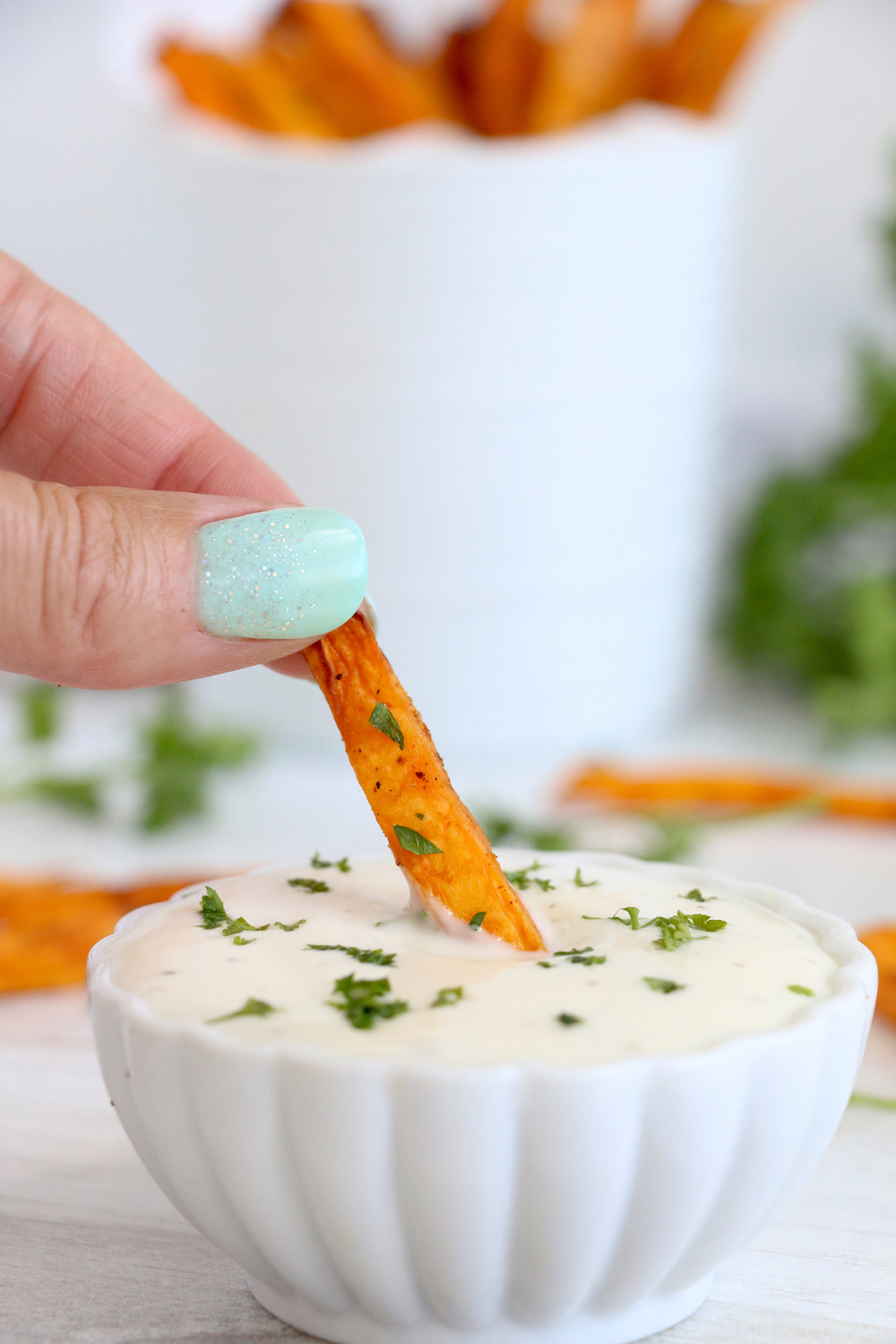 dipping sweet potato fry in ranch dressing