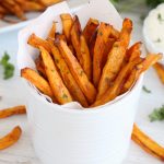 white cup with sweet potato fries