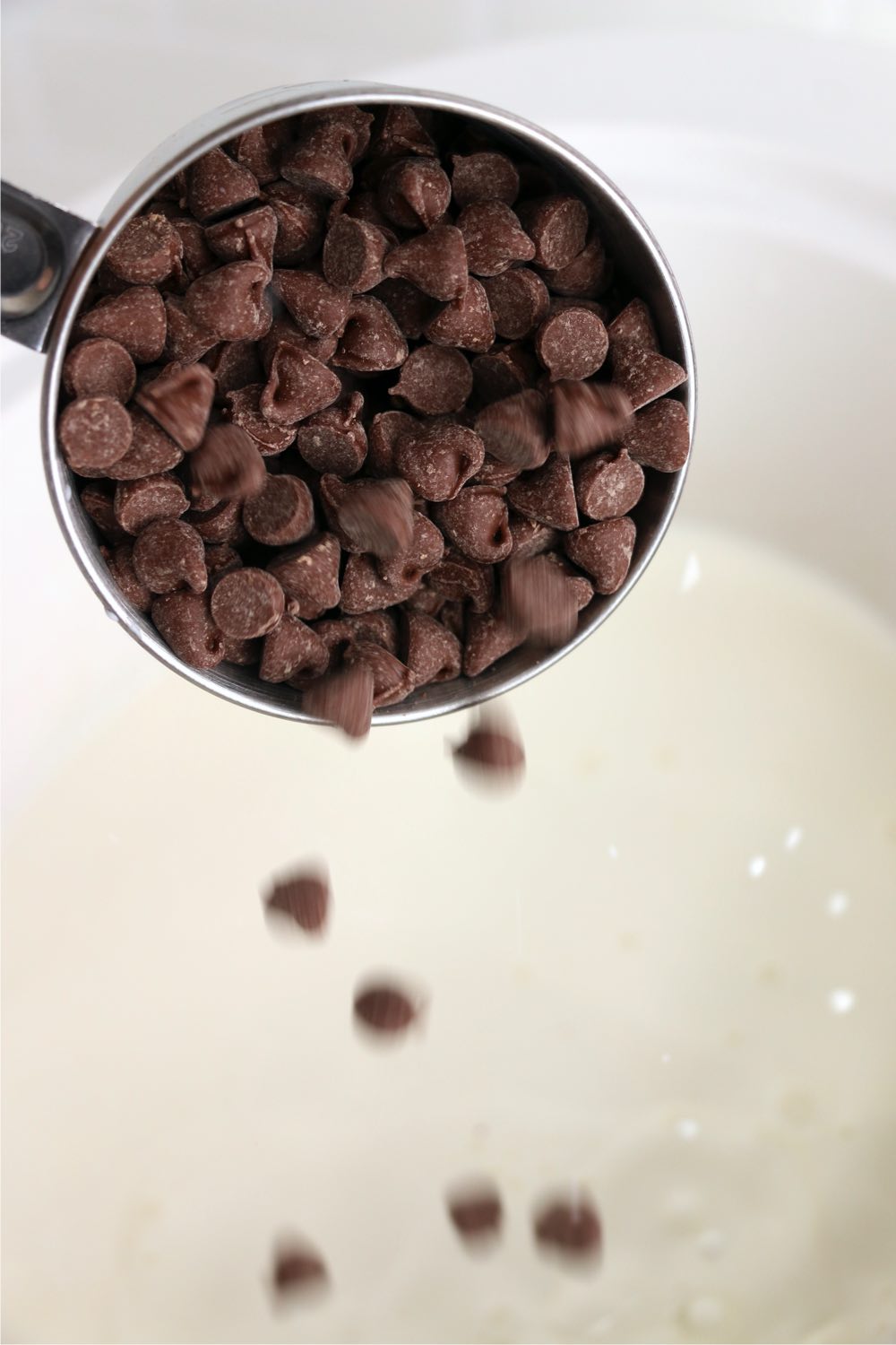 Adding chocolate chips to milk in a slow cooker