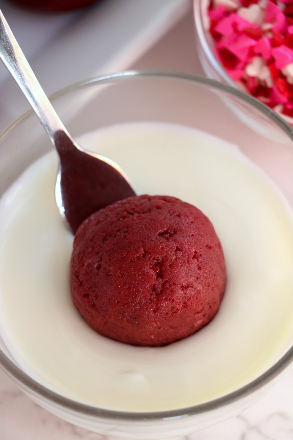 dipping red velvet cake balls in white chocolate
