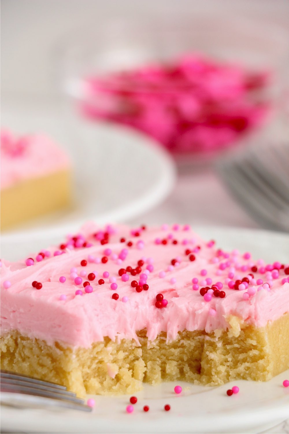 bite out of a frosted pink cake bars